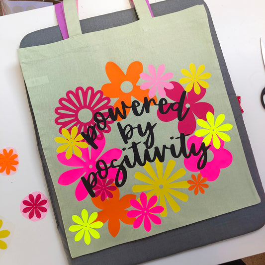 POWERED BY POSITIVITY tote bag